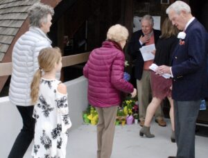 usher welcoming people to church